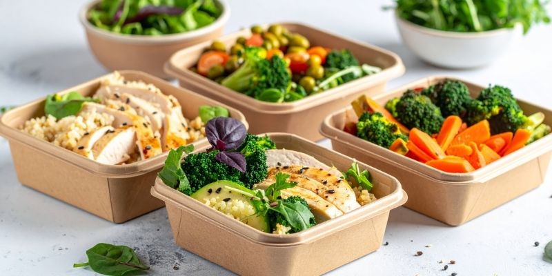 Homemade dog food prepared in advance in portion containers for busy owners