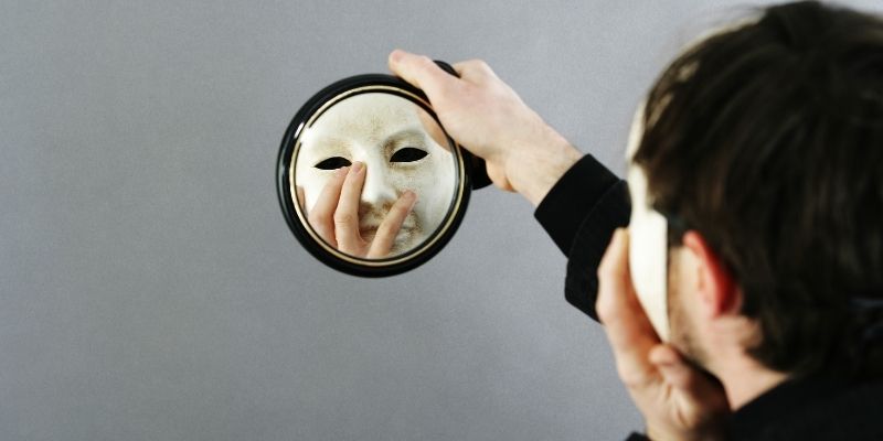 A dog looking deeply at its owner who is wearing a metaphorical mask of stress