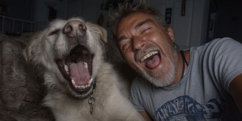 A relaxed owner laughing and hugging their happy dog showing pureloveandharmony and genuine emotional alignment